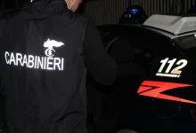 militare con pettorina Carabinieri sta per entrare in automobile di servizio dell'Arma